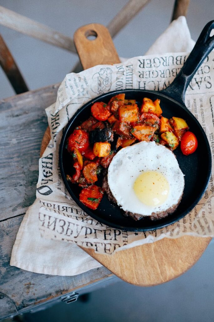 eggs, potatoes and tomatoes in a frying pan